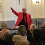 Neil Roberts talking about</br>the history of Pantomime & audience participation<br>in "Sister Susie Sewing Shirts for Sailors...'